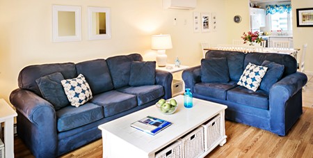 View of White Table & Blue Couches & Loveseats in Mattakesett Townhouse B7