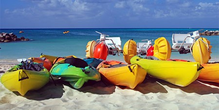 Colorful Kayaks on the Beach - Featured Image