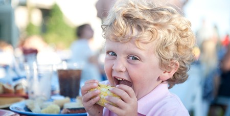 Littel Boy Smiling & Eating Corn at the Winnetu Clambake