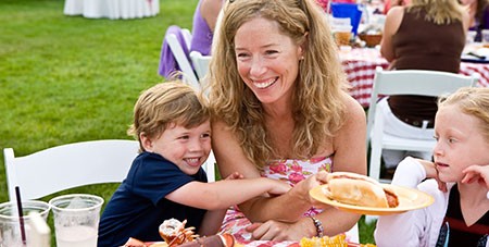 Mother and son enjoying clambake at the Winnetu - Featured Image