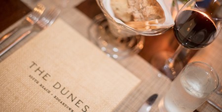 View of Menu, Glasses of Wine & Water & Bread at The Dunes Restaurant