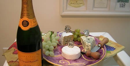 Bottle of Veuve Clicquot Champagne and Fruit and Cheese on a Tray Display