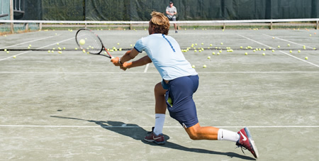 Man Returning a Serve on the Tennis Courts at the Mattakesett Tennis Club on Martha's Vineyard