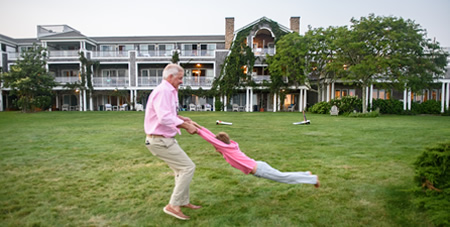 Grandfather Swinging Grandson by the Arms on the Winnetu Front Lawn