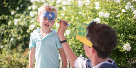 Boy Getting His Face Painted wtih a Super Hero Mask at the Winnetu's Children's Day Program