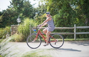 Woman riding bike on path