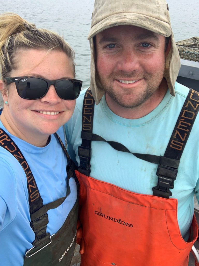 A smiling man and a smiling woman with sunglasses on