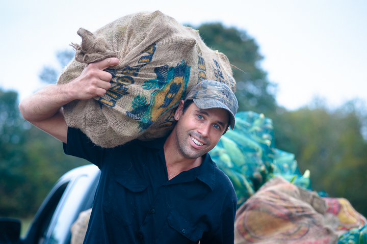 A man carrying a burlap bag on his shoulder