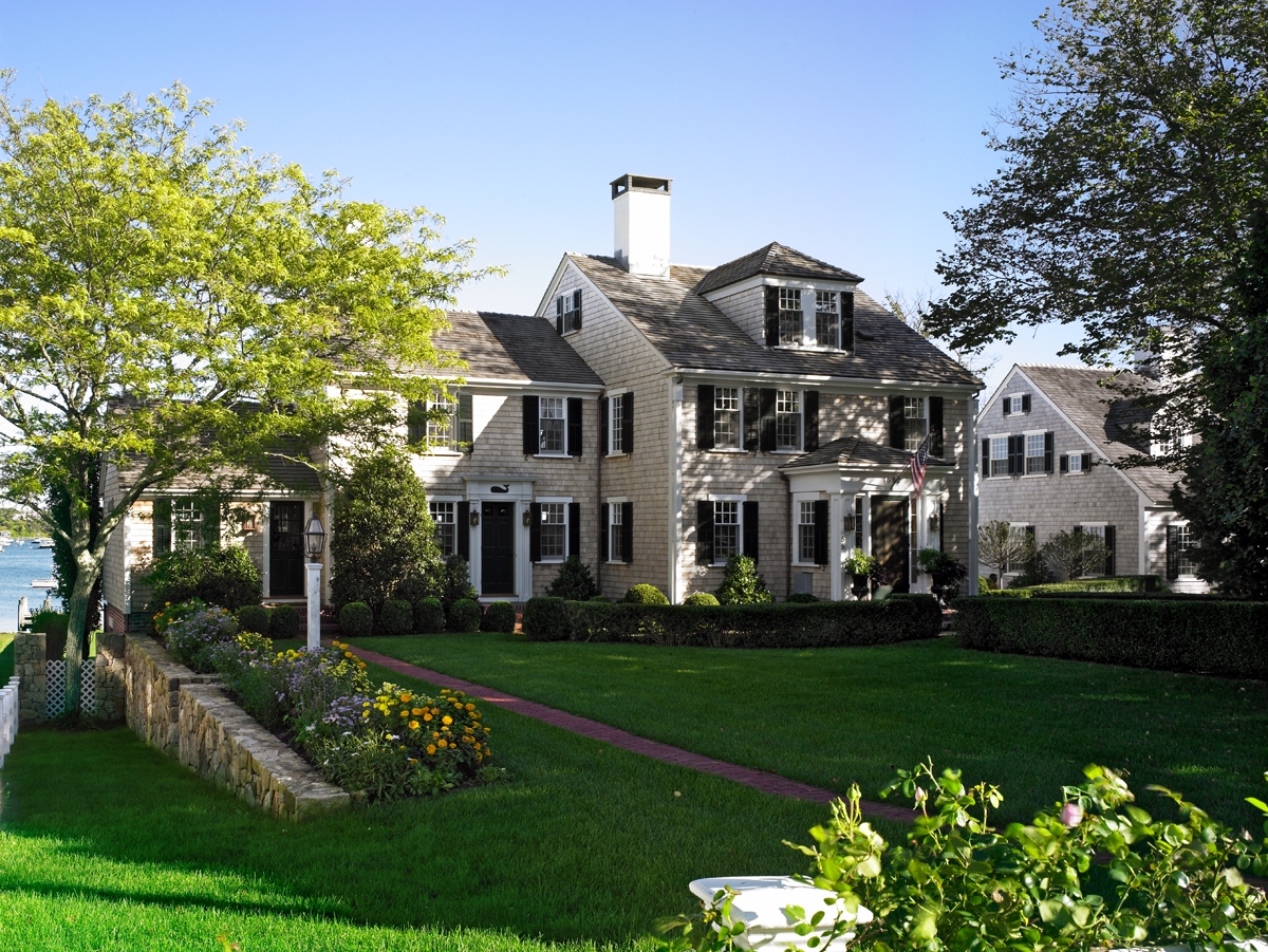 A large house with a beautiful green lawn in front of it