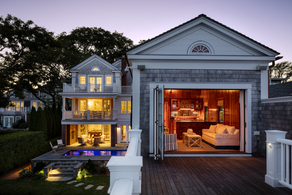 A modern house with a wide open living room and bar behind it